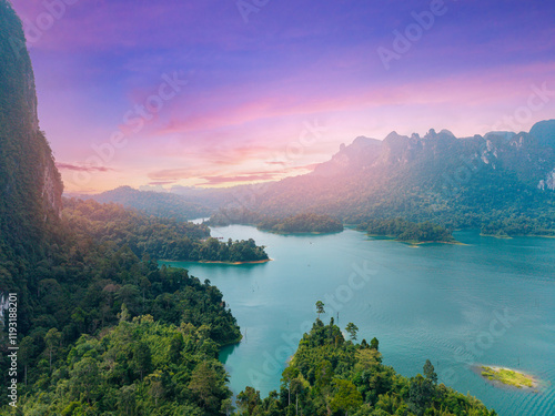 Stunning sunset over limestone cliffs in Khao Sok Cheow Lan Dam lake National park, Thailand photo