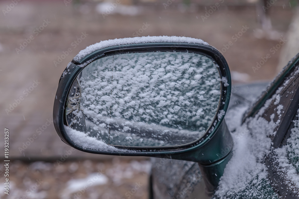 Car wing mirror covered up with fresh wet snow. Car wing mirror covered up with fresh wet snow.