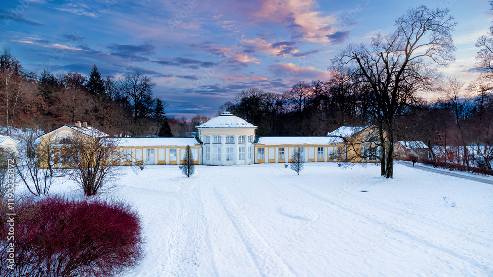 Small colonnade in Marianske Lazne (Marienbad) - snow winter in spa park. Spa architecture - evening colonnade of cold mineral water spring Ferdinand - Czech Republic, Europe