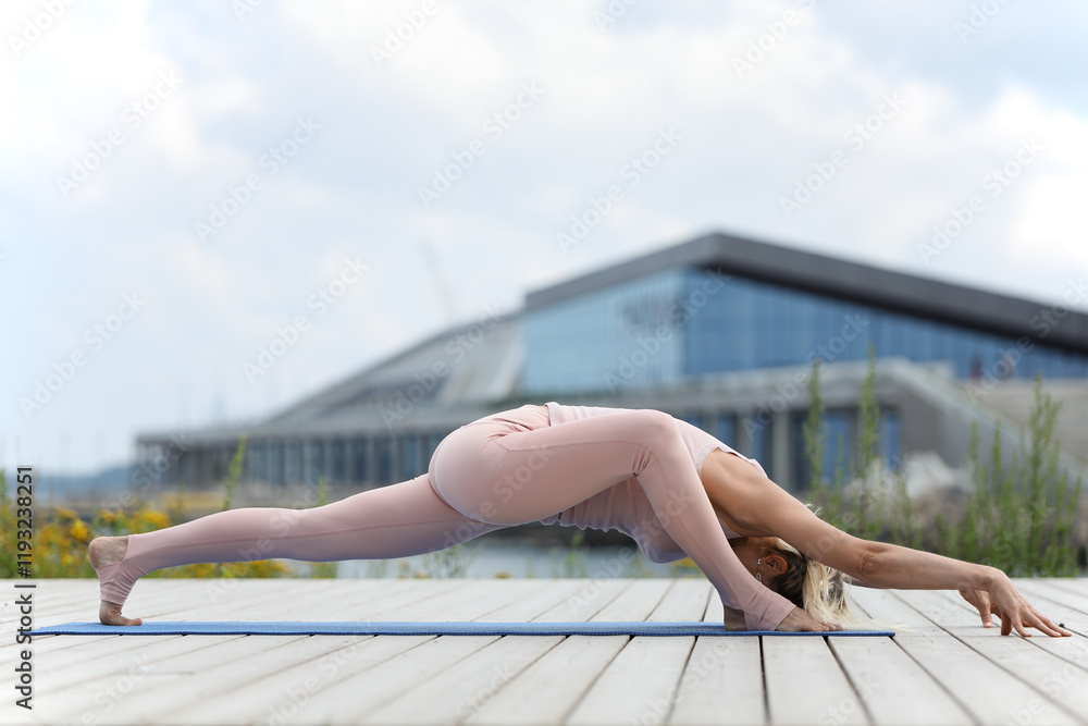A woman practices yoga on wooden deck A woman practices yoga on wooden deck