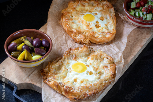 Khachapuri made from filo dough, with egg and melted cheese.
 photo