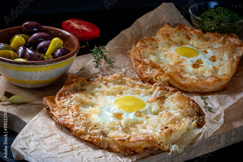 Khachapuri made from filo dough, with egg and melted cheese.
 photo