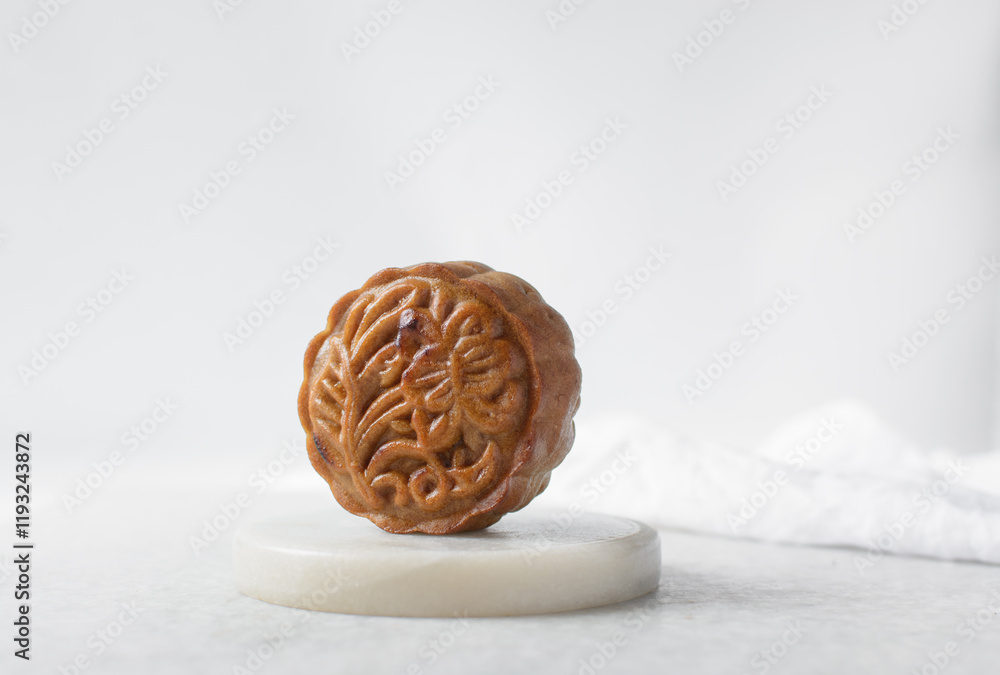 Fototapeta premium homemade mooncakes on a white background, top view of baked mooncakes on white table, process of making mooncakes for Lunar New Year and mid autumn festival
