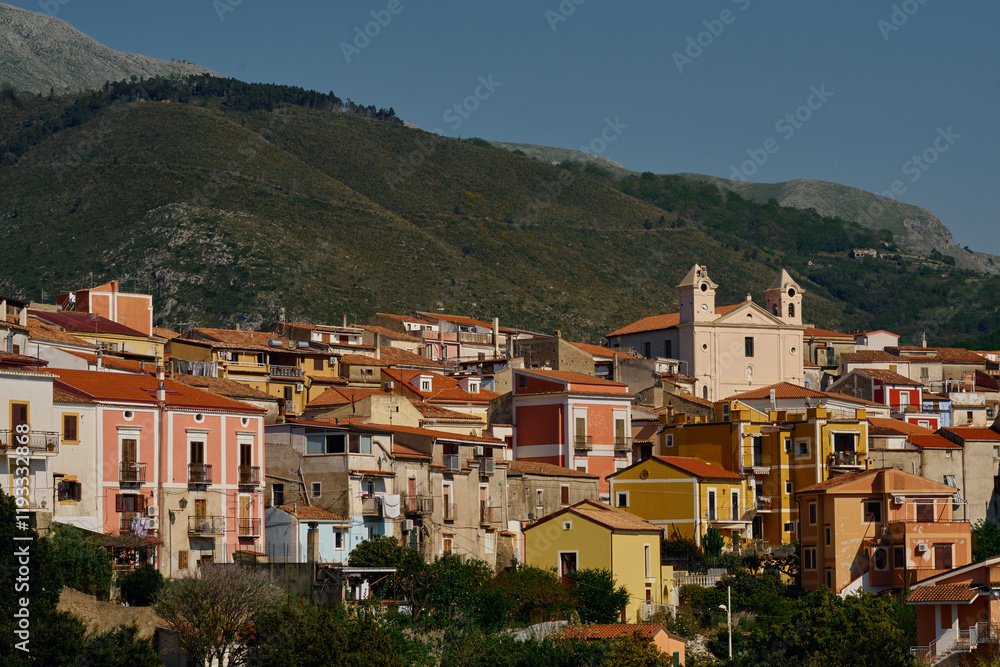 Scenic village with towering buildings and mountains in San Nico Scenic village with towering buildings and mountains in San Nico