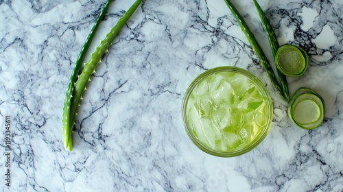 Refreshing Aloe Vera Drink with Ice and Lime on Marble Surface photo