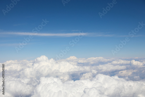 view from the airliner of clouds and the blue sky above with nothing else photo