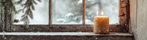 Lit candle on snowy windowsill during winter snowfall.