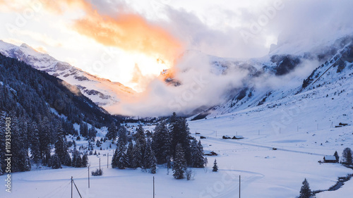 Scenery aerial view from drone of mountain snowy peaks in winter before sunset, bird’s eye view of beautiful nature landscape under breathtaking sky photo