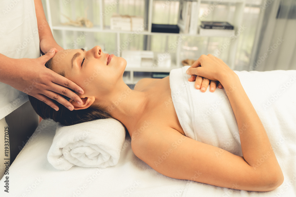 Caucasian woman enjoying relaxing anti-stress head massage and pampering facial beauty skin recreation leisure in dayspa modern light ambient at luxury resort or hotel spa salon. Quiescent Caucasian woman enjoying relaxing anti-stress head massage and pampering facial beauty skin recreation leisure in dayspa modern light ambient at luxury resort or hotel spa salon. Quiescent