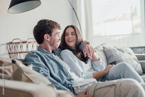 Canvas Print Portrait of young 20s just married couple in love posing photo shooting seated on couch in modern studio apartments, concept of capture happy moment, harmonic relationships, care and sincere feelings
