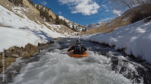 Adventurous Riverboarding Through Snowy Rapids Surrounded by Scenic Winter Mountain Landscape photo