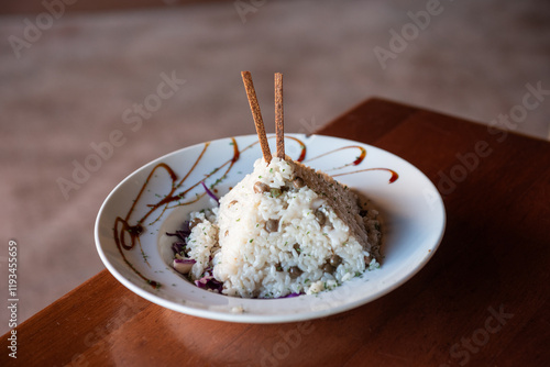 Obraz na płótnie Puerto Rican Arroz con Gandules (Rice and Pigeon Peas) artfully shaped into a pyramic on a garnished plate and served at a Luquillo Kiosk