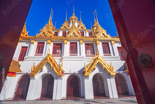 Exterior Loha Prasat temple in Wat Ratchanatdaram Worawihan in Bangkok in sunlight Thailand photo