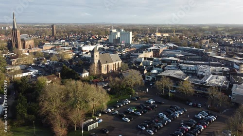 Raalte, the Netherlands - January 10th 2025: Aerial footage of the town center. Drone flying backwards over mayor parking lots. photo