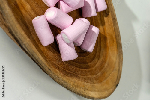 Wooden tray with pink marshmallows, perfect for cozy, sweet moments and food-related themes. Ideal for dessert, party, and confectionery photography. photo