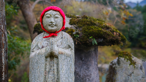 Jizo Bodhisattva (O-Jizo-sama) statue on the roadside of a small mountain farming village in the westernmost region of Tokyo Prefecture, Japan. photo