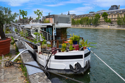 Houseboat on the Seine River with Musee d'Orsay in the Background photo