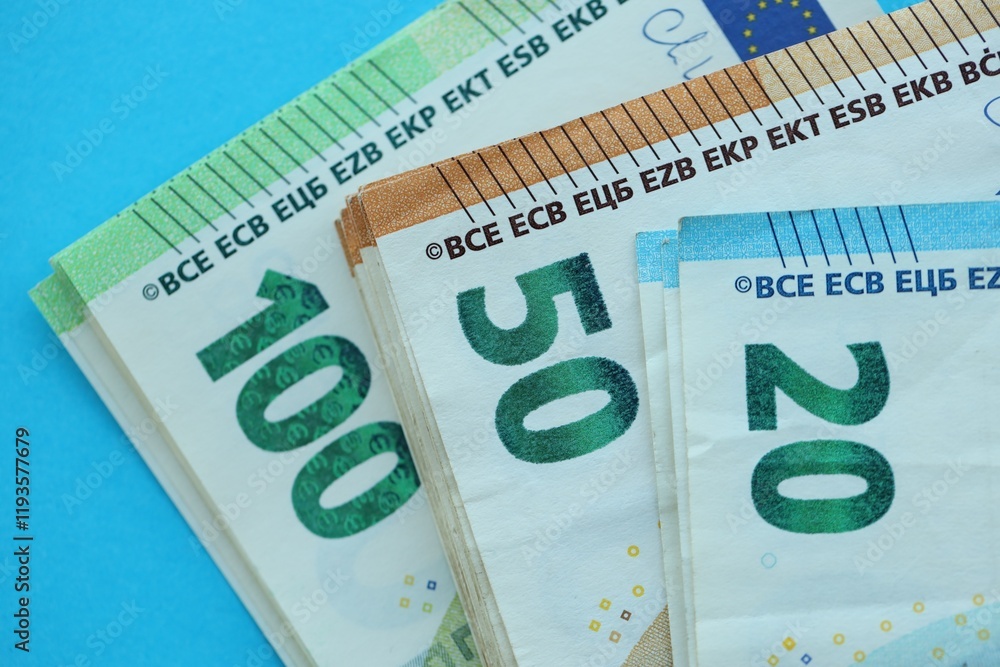 Big amount of one hundred, twenty and fifty euro money bills on blue background Big amount of one hundred, twenty and fifty euro money bills on blue background