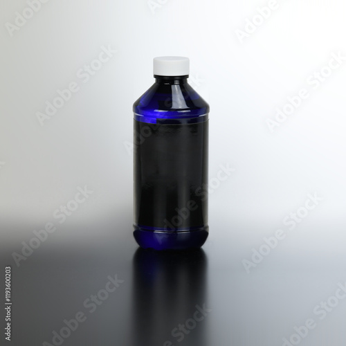 Liquid cosmetic bottle with blank label for product presentation. Blue container with black label mock-up.