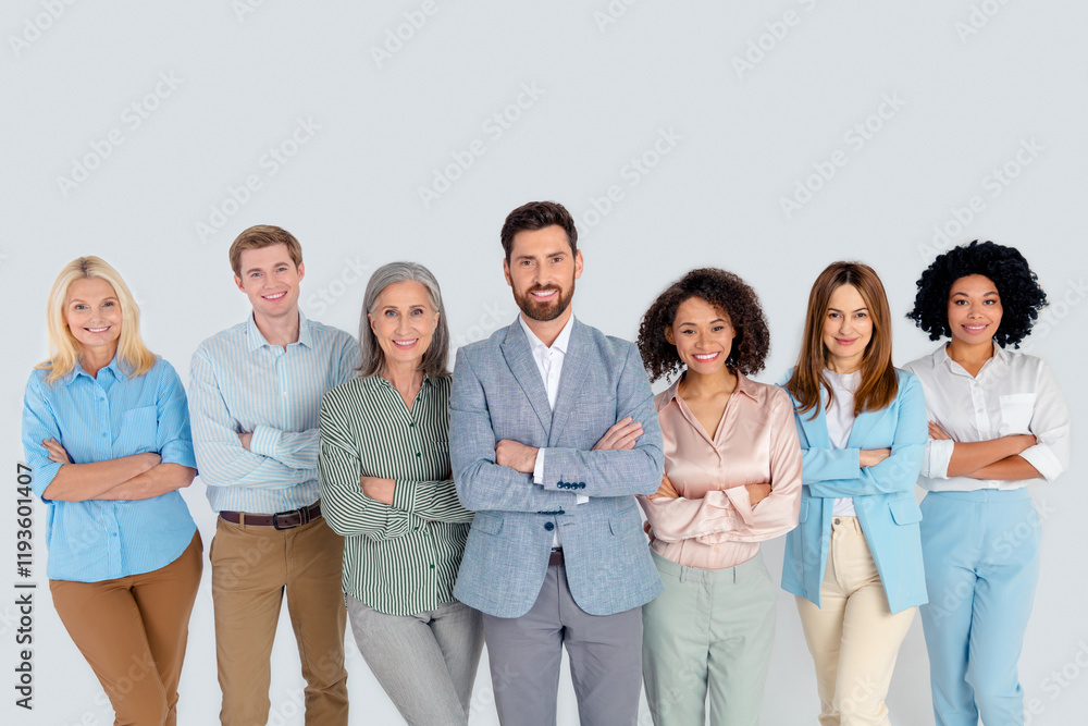 Diverse group of professionals standing together on a grey background, representing teamwork and collaboration in a modern workplace Diverse group of professionals standing together on a grey background, representing teamwork and collaboration in a modern workplace