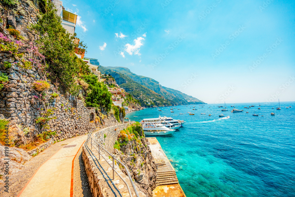 Naklejka premium Positano coastline in south of Italy, vertiginous cliffs adorned with colorful villages, turquoise waters. Small town Positano on Amalfi Coast near Neapol, Italy
