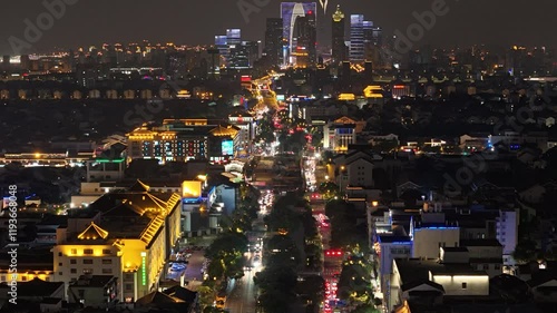 Nighttime timelapse of Suzhou Ganjiang Road illuminated by vibrant city lights photo