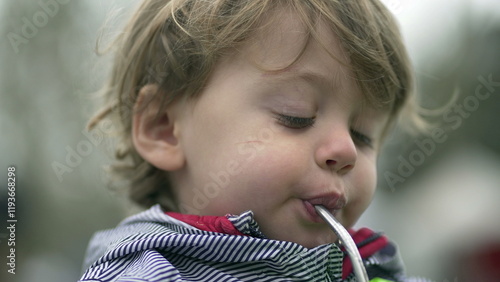 Child drinking juice with straw, little boyd drink snack photo