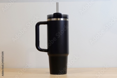 Isolated Black Insulated Tumbler with Straw Against White Background. Reusable, Eco-friendly, and Portable Beverage Container for Everyday Hydration