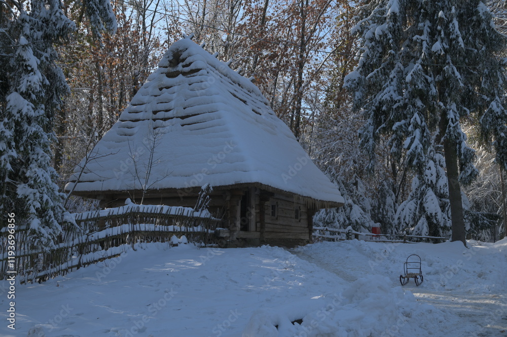 wooden house with a thatched roof in the forest in winter wooden house with a thatched roof in the forest in winter