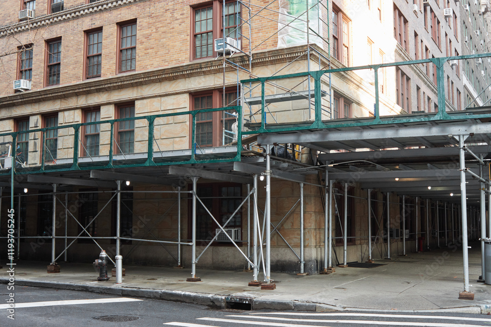 Naklejka premium scaffolding surrounding a pre-war residential apartment building on the uppwer west side of Manhattan, New York