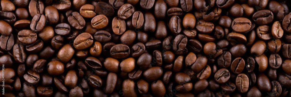 Obraz premium Hot and Rich Coffee Beans Background. Perfect Texture and Roasted Bean for your Cafe and Caffeine Needs