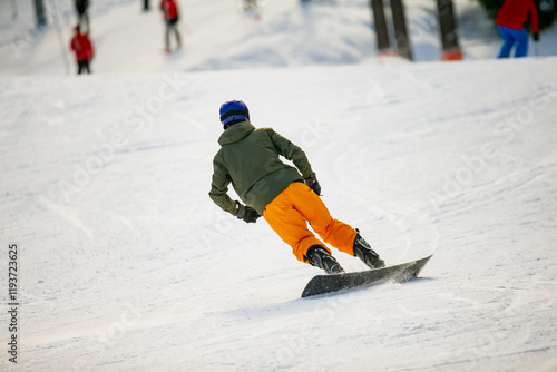 Extreme ski slope slalom snowboarder. Fast snowboarder of skilled move driving downhill skiing track in fast motion with big carves in snow photo