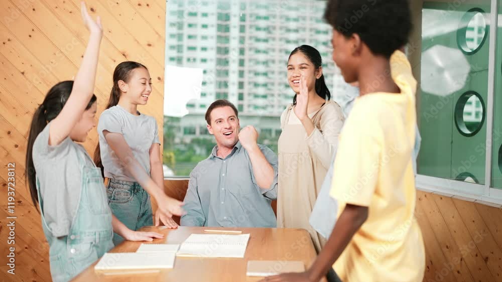 Caucasian teacher and diverse children putting hand together to celebrate successful project or encourage in classroom. Represent love, corporate, team working, togetherness and unity. Edification Caucasian teacher and diverse children putting hand together to celebrate successful project or encourage in classroom. Represent love, corporate, team working, togetherness and unity. Edification
