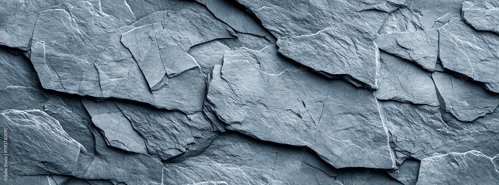 Close-up of textured slate stone wall in shades of grey. This natural stone surface is ideal for architectural backgrounds, design projects, or as a unique wallpaper alternative. Close-up of textured slate stone wall in shades of grey. This natural stone surface is ideal for architectural backgrounds, design projects, or as a unique wallpaper alternative.