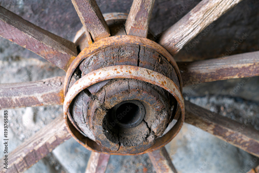 Old wooden wheel against the wall. Village life. Old wooden wheel against the wall. Village life.
