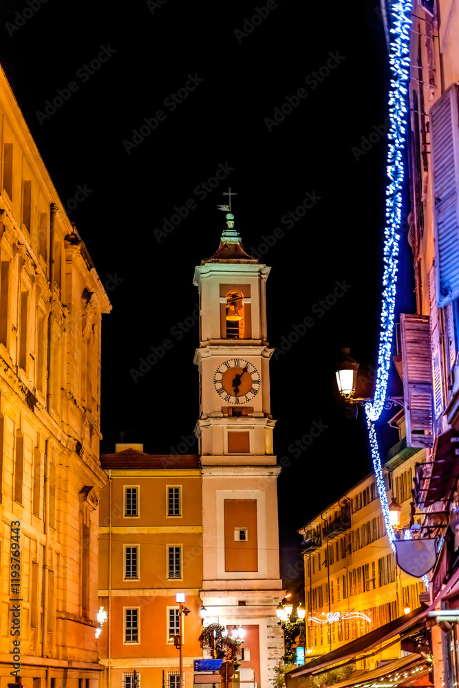 Fototapeta premium Christmas decoration outside Saint Marie and Saint Reparte de Nice, Cote d'Azur, France. Church built in 1600's, steeple in 1700's