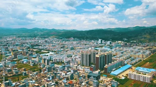 Aerial views of Lijiang city showcasing urban landscape and surrounding mountains in Yunnan province photo