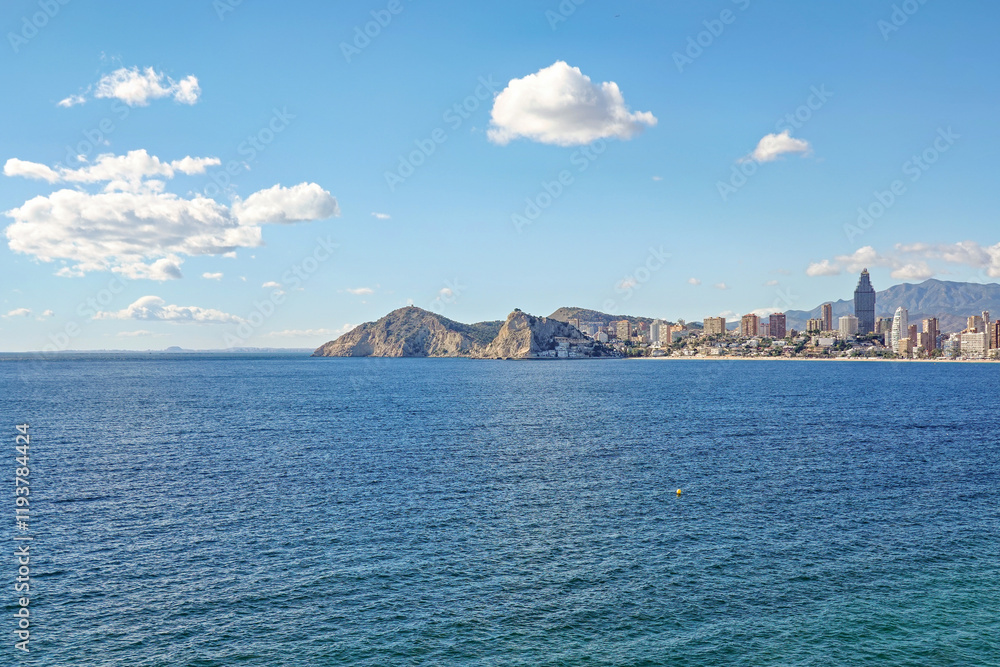 Beautiful view to Mediterranean Sea and Benidorm resort city and Poniente beach.Benidorm is a popular coastal resort town in Alicante province, Spain Beautiful view to Mediterranean Sea and Benidorm resort city and Poniente beach.Benidorm is a popular coastal resort town in Alicante province, Spain