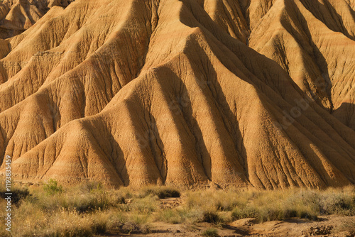 A close view of the unique sandstone formations in Bardenas Reales. The rugged terrain and warm colors showcase the natural artistry of this arid landscape. photo