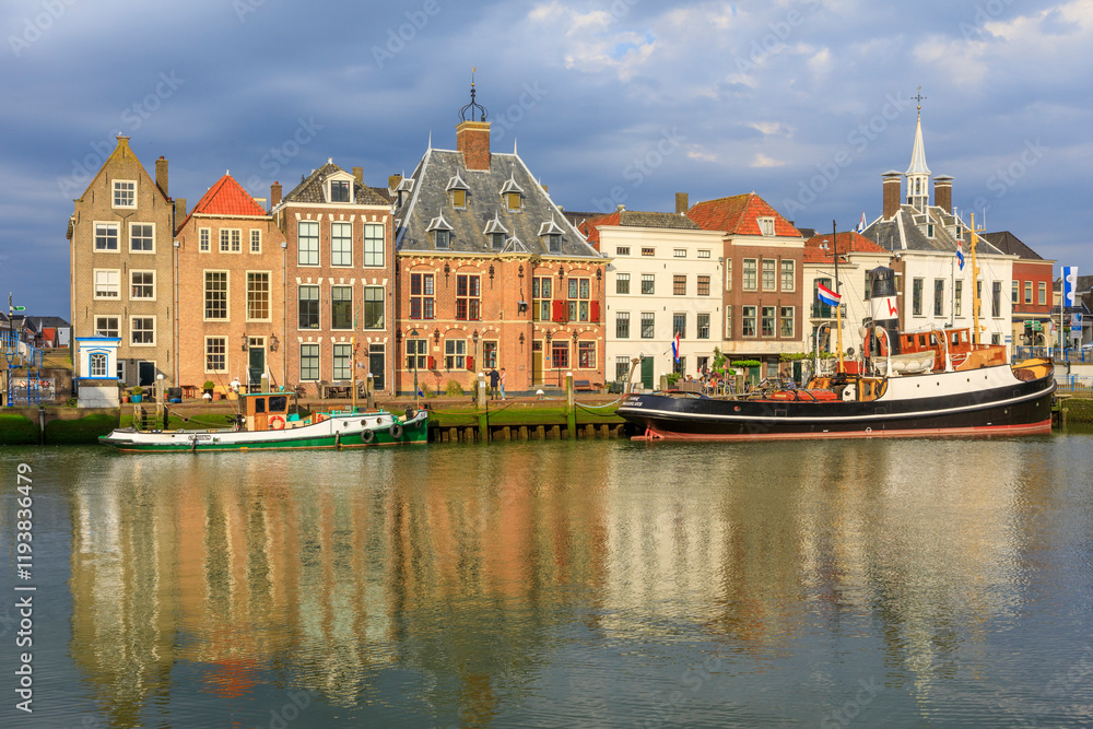 Naklejka premium Netherlands, Zuid Holland, Maassluis. Harbor boats and row houses.
