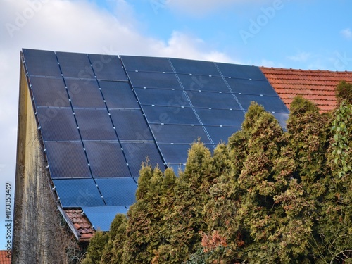 An old and sloping roof on which solar modules are optimally installed photo