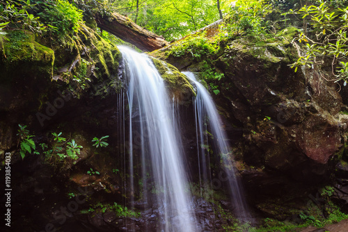 A waterfall is flowing down a rocky cliff