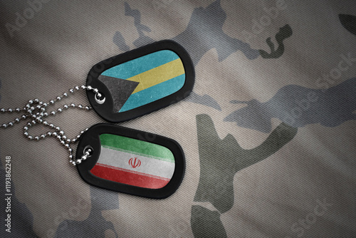 vintage army blank, dog tag with flag of bahamas and iran on the khaki texture background. military concept. photo