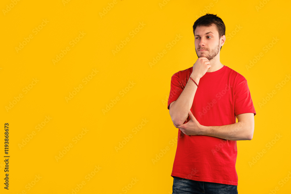 Portrait of pensive funny guy thinking about question, touching chin and looking away at copy space, contemplating about idea. Young man standing isolated over blue studio background Portrait of pensive funny guy thinking about question, touching chin and looking away at copy space, contemplating about idea. Young man standing isolated over blue studio background