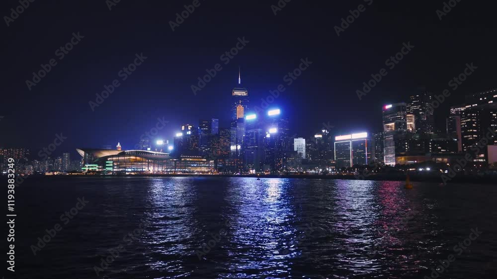 Vibrant night life illuminates Hong Kong skyline across the water with colorful city lights and bustling atmosphere Vibrant night life illuminates Hong Kong skyline across the water with colorful city lights and bustling atmosphere