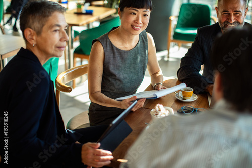 Diverse business people having meeting in modern cafe photo