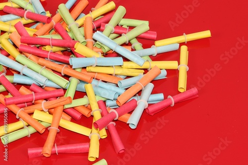 pile of colorful tombola tickets lying on a red background