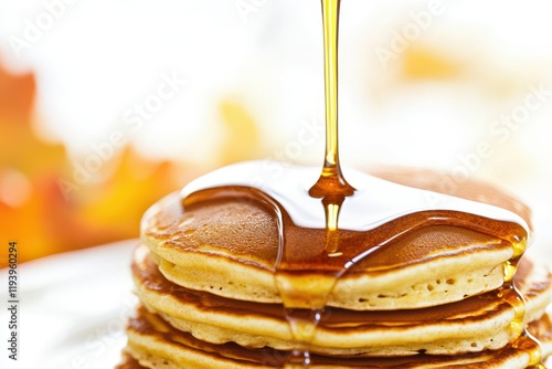 Delicious pancakes topped with syrup, perfect for a breakfast treat. photo