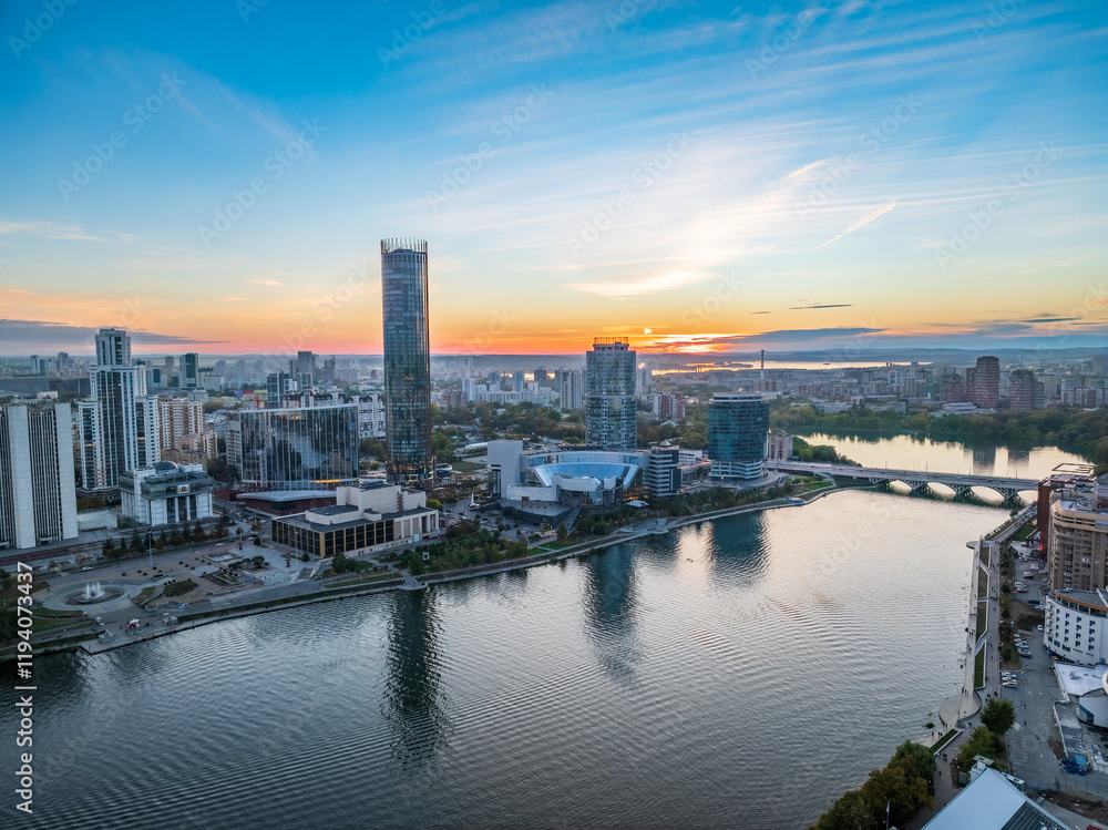 Obraz premium Yekaterinburg city and pond aerial panoramic view at summer or early autumn sunset. Night city in the early autumn or summer.