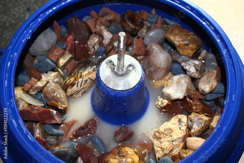 Fotografie Vibratory tumbling bowl filled with stones for processing